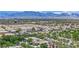 Aerial view of the community with lush green landscaping, palm trees, and mountain views at 8134 Maddingley Ave, Las Vegas, NV 89117