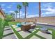 A verdant backyard offers an inviting retreat with ample lawn space and desert landscaping at 8134 Maddingley Ave, Las Vegas, NV 89117