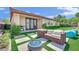 Backyard with a nice seating area, an outdoor grill, artificial turf and pavers with a fire pit at 8134 Maddingley Ave, Las Vegas, NV 89117