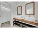 Stylish bathroom featuring dual sinks, marble countertops, and modern fixtures at 8134 Maddingley Ave, Las Vegas, NV 89117
