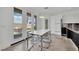 Bright dining room with modern table, chairs, tile flooring, and sliding glass doors to the backyard at 8134 Maddingley Ave, Las Vegas, NV 89117