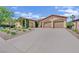 Charming single-story home with a well-manicured yard, two-car garage, desert landscaping, and a long driveway at 8134 Maddingley Ave, Las Vegas, NV 89117