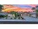 Charming single-story home with a well-manicured yard and two-car garage, enhanced by a colorful sunset backdrop at 8134 Maddingley Ave, Las Vegas, NV 89117