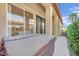Exterior view showcasing sliding glass doors, patio cover, and tidy landscaping at 8134 Maddingley Ave, Las Vegas, NV 89117