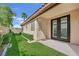 Home exterior with glass block window, french doors, verdant lawn, and privacy landscaping at 8134 Maddingley Ave, Las Vegas, NV 89117