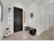 Contemporary entryway with a dark wood front door, bench seating, and minimalist decor under bright lighting at 8134 Maddingley Ave, Las Vegas, NV 89117