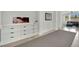 Modern hallway with built-in white cabinetry and dark hardware, leading to a naturally lit seating area at 8134 Maddingley Ave, Las Vegas, NV 89117