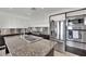 Bright kitchen features stainless steel appliances, a center island, and granite countertops at 8134 Maddingley Ave, Las Vegas, NV 89117