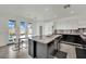 Modern kitchen with an island, stainless steel appliances, sleek white cabinetry, and seamless access to an outdoor patio at 8134 Maddingley Ave, Las Vegas, NV 89117