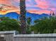 Beautiful mountain views with desert landscaping elements of bushes and cactus with a blue and pink sunset at 8134 Maddingley Ave, Las Vegas, NV 89117