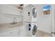 Functional laundry area with stacked washer/dryer and convenient storage at 8134 Maddingley Ave, Las Vegas, NV 89117