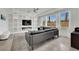Spacious living room with built-in shelving, a modern fireplace, large windows, and a comfortable leather sofa at 8134 Maddingley Ave, Las Vegas, NV 89117
