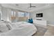 Bright main bedroom featuring a tray ceiling, large window, and ample natural light at 8134 Maddingley Ave, Las Vegas, NV 89117