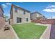 Landscaped backyard with artificial grass, patio area and wooden bench seating perfect for outdoor relaxation at 8755 Spanish Ridge Ave, Las Vegas, NV 89148