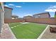 Large backyard featuring artificial grass and concrete pavers, offering a perfect low-maintenance outdoor space at 8755 Spanish Ridge Ave, Las Vegas, NV 89148
