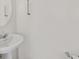 Elegant half-bathroom featuring a pedestal sink with chrome fixtures at 8755 Spanish Ridge Ave, Las Vegas, NV 89148