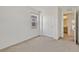 Neutral bedroom featuring plush carpeting, a window with blinds, and a closet for ample storage at 8755 Spanish Ridge Ave, Las Vegas, NV 89148