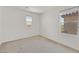 This bedroom features neutral colored walls and carpet, as well as two windows that provide plenty of natural light at 8755 Spanish Ridge Ave, Las Vegas, NV 89148