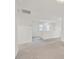 Bright upper hallway featuring neutral carpet and two windows at 8755 Spanish Ridge Ave, Las Vegas, NV 89148
