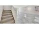 Hallway featuring staircase, marble floors, and natural light from windows at 8755 Spanish Ridge Ave, Las Vegas, NV 89148