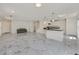 Expansive living area featuring sleek marble floors, modern lighting, and a staircase to the second level at 8755 Spanish Ridge Ave, Las Vegas, NV 89148