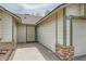 Neutral home featuring rock accents, a modern front door, and a one-car garage at 901 Clipper Dr, Henderson, NV 89015