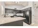 Modern kitchen features dark cabinets, quartz countertops, and stainless steel appliances at 901 Clipper Dr, Henderson, NV 89015