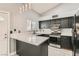 Stylish kitchen with stainless steel appliances, dark cabinetry and quartz countertops at 901 Clipper Dr, Henderson, NV 89015