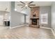 Open living room with fireplace, high ceilings, wood-look flooring, and modern lighting at 901 Clipper Dr, Henderson, NV 89015