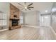 Comfortable living room with fireplace, high ceilings, wood-look flooring, and natural light at 901 Clipper Dr, Henderson, NV 89015