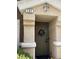 A close up of the house's front door with plants and a decorative wreath at 9133 Forest Willow Ave # 102, Las Vegas, NV 89149