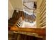 A view looking down a staircase with wooden handrails at 9133 Forest Willow Ave # 102, Las Vegas, NV 89149