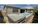 This backyard features a swimming pool and a covered patio area with sliding glass doors at 9638 Smiley Creek St, Las Vegas, NV 89178