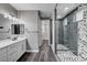 Modern bathroom showcasing a dual sink vanity and a glass-enclosed shower with elegant tile work at 9638 Smiley Creek St, Las Vegas, NV 89178