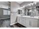 Bright bathroom boasts a dual sink vanity, modern lighting, and wood-look floors at 9638 Smiley Creek St, Las Vegas, NV 89178