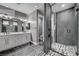 Modern bathroom featuring glass shower and double sink vanity with white countertop at 9638 Smiley Creek St, Las Vegas, NV 89178