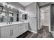 Modern bathroom featuring a dual sink vanity with white countertop and dark wood-look floors at 9638 Smiley Creek St, Las Vegas, NV 89178