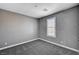 Neutral bedroom featuring plush carpet, gray walls and a window with white shutters at 9638 Smiley Creek St, Las Vegas, NV 89178