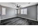 Bedroom with dark wood floors and white shutters at 9638 Smiley Creek St, Las Vegas, NV 89178