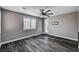 Bedroom with dark wood floors and white shutters at 9638 Smiley Creek St, Las Vegas, NV 89178