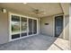 Relaxing covered patio area with ceiling fan, lights, and sliding glass door access to the home at 9638 Smiley Creek St, Las Vegas, NV 89178