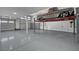 Showcasing an immaculate garage with epoxy flooring and a car lift for car enthusiasts at 9638 Smiley Creek St, Las Vegas, NV 89178