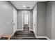 Hallway with modern gray walls, dark wood-style floors, and access to a closet with built-in shelving at 9638 Smiley Creek St, Las Vegas, NV 89178