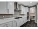 White kitchen with stainless steel appliances, gas cooktop, and pantry at 9638 Smiley Creek St, Las Vegas, NV 89178
