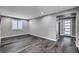 Bright, modern living room featuring gray walls and dark wood-style floors at 9638 Smiley Creek St, Las Vegas, NV 89178