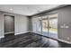 Living room with sliding glass doors, wood-look floors, and view of the backyard at 9638 Smiley Creek St, Las Vegas, NV 89178