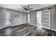 Spacious main bedroom with dark wood-style floors, a ceiling fan, and a sliding door to the main bathroom at 9638 Smiley Creek St, Las Vegas, NV 89178