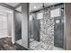 Contemporary shower with a glass enclosure and stylish black and white patterned tile at 9638 Smiley Creek St, Las Vegas, NV 89178