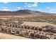 Scenic aerial view of a modern residential neighborhood with mountain views in the distance at 9715 Harper Edge St, Las Vegas, NV 89143