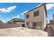 Exterior view of home with a fenced yard, sliding glass doors, and blue skies at 9715 Harper Edge St, Las Vegas, NV 89143